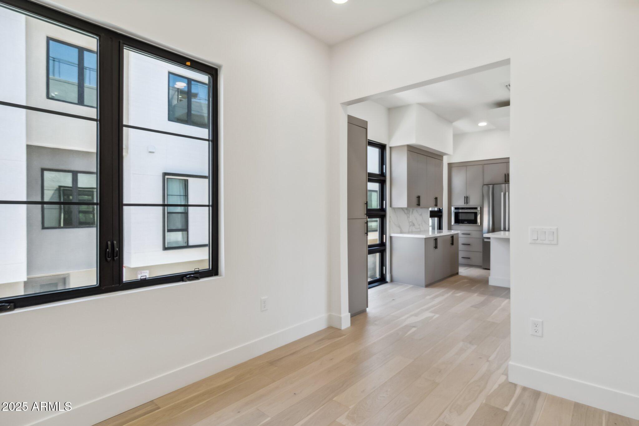 1501 North Miller Road, Unit 1016 Scottsdale, AZ 85257 - Photo 9 of 23 a view of a kitchen with wooden floor and a kitchen