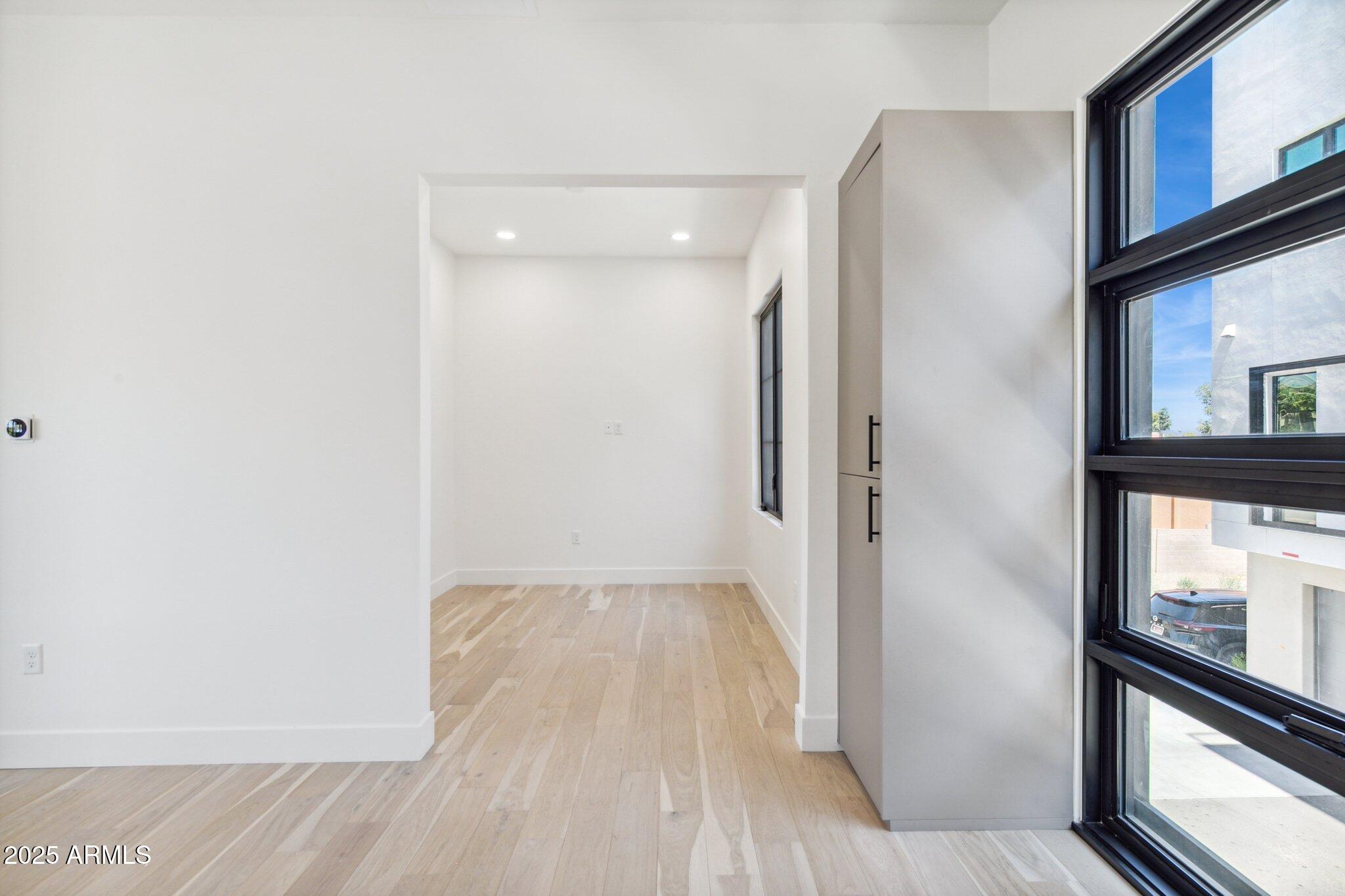 1501 North Miller Road, Unit 1016 Scottsdale, AZ 85257 - Photo 10 of 23 a view of a hallway with wooden floor and a bathroom