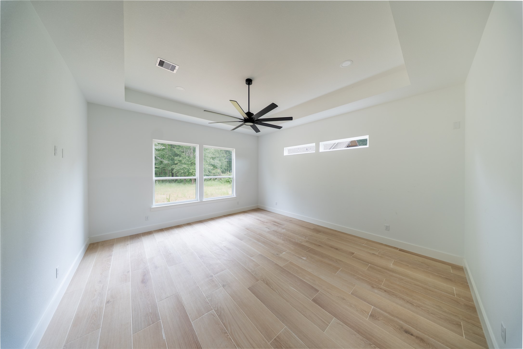 17018 North Saba Court Splendora, TX 77372 - Photo 7 of 10 Primary bedroom offers high tray ceilings with upgraded tile flooring