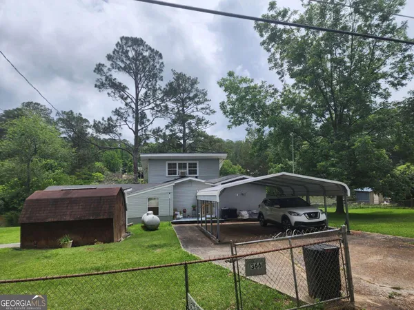 a view of a yard with furniture and a fire pit