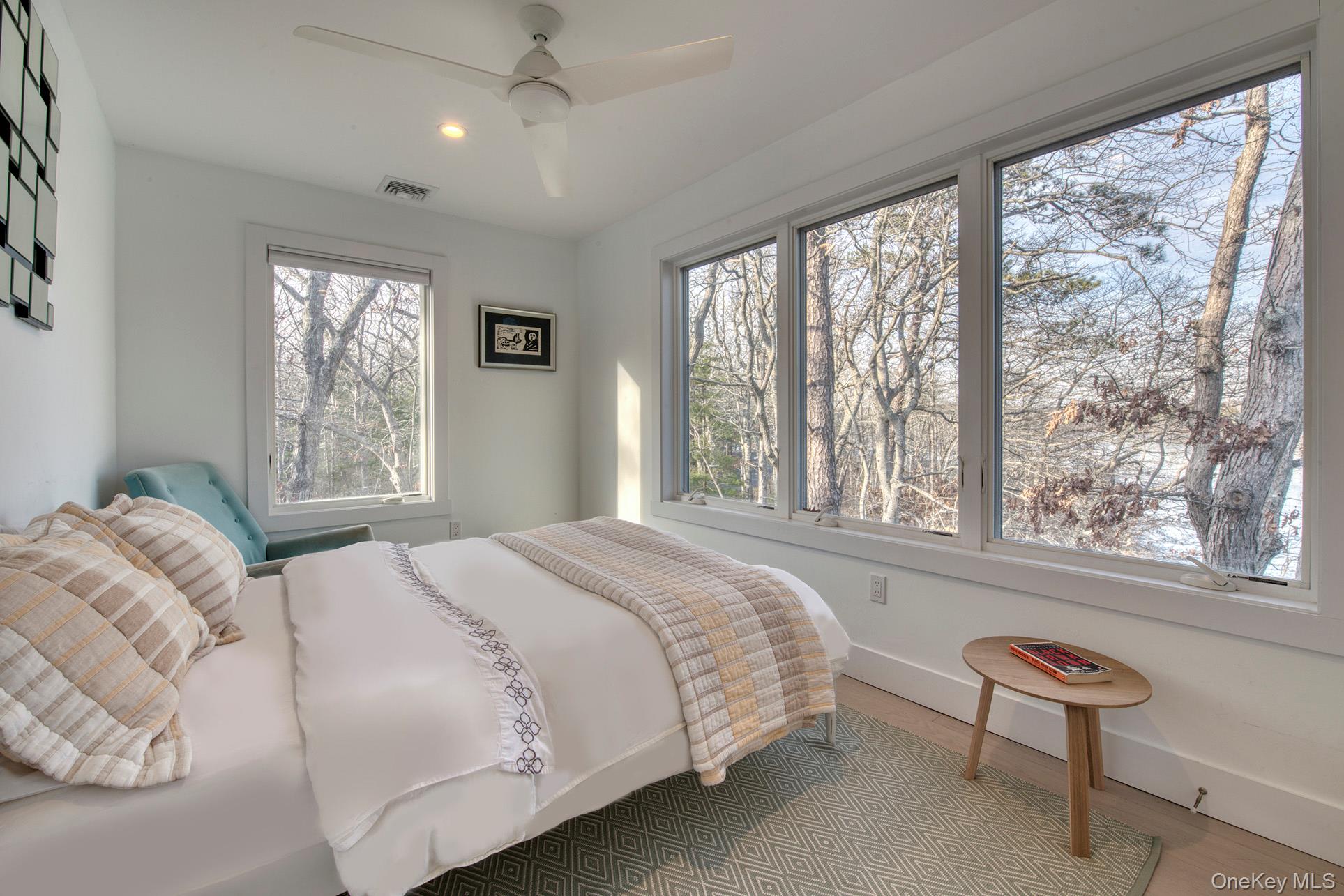 57 Big Fresh Pond Road Southampton, NY 11968 - Photo 13 of 18 a bedroom with a bed and a large window