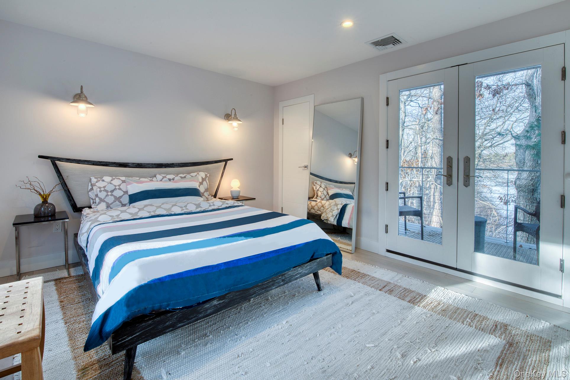 57 Big Fresh Pond Road Southampton, NY 11968 - Photo 14 of 18 a bedroom with a bed and a large window