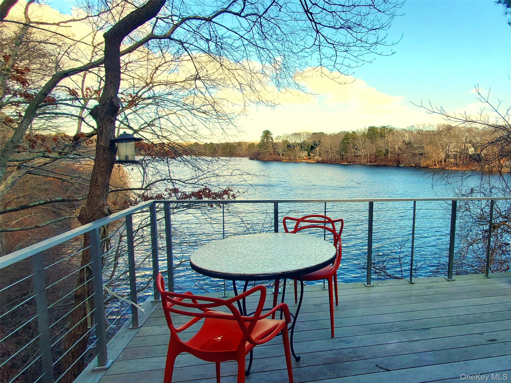 57 Big Fresh Pond Road Southampton, NY 11968 - Photo 16 of 18 a balcony with table and chairs