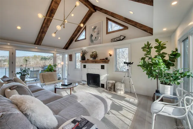a living room with furniture a fireplace and a potted plant