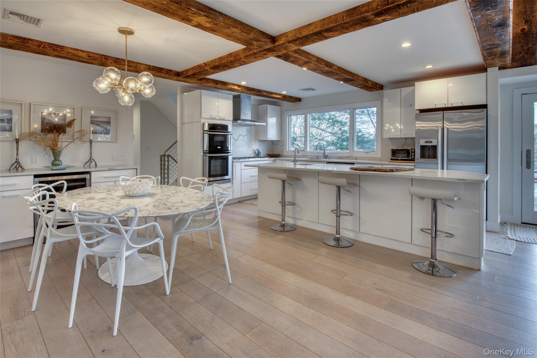 57 Big Fresh Pond Road Southampton, NY 11968 - Photo 3 of 18 a view of a dining room with furniture window and wooden floor