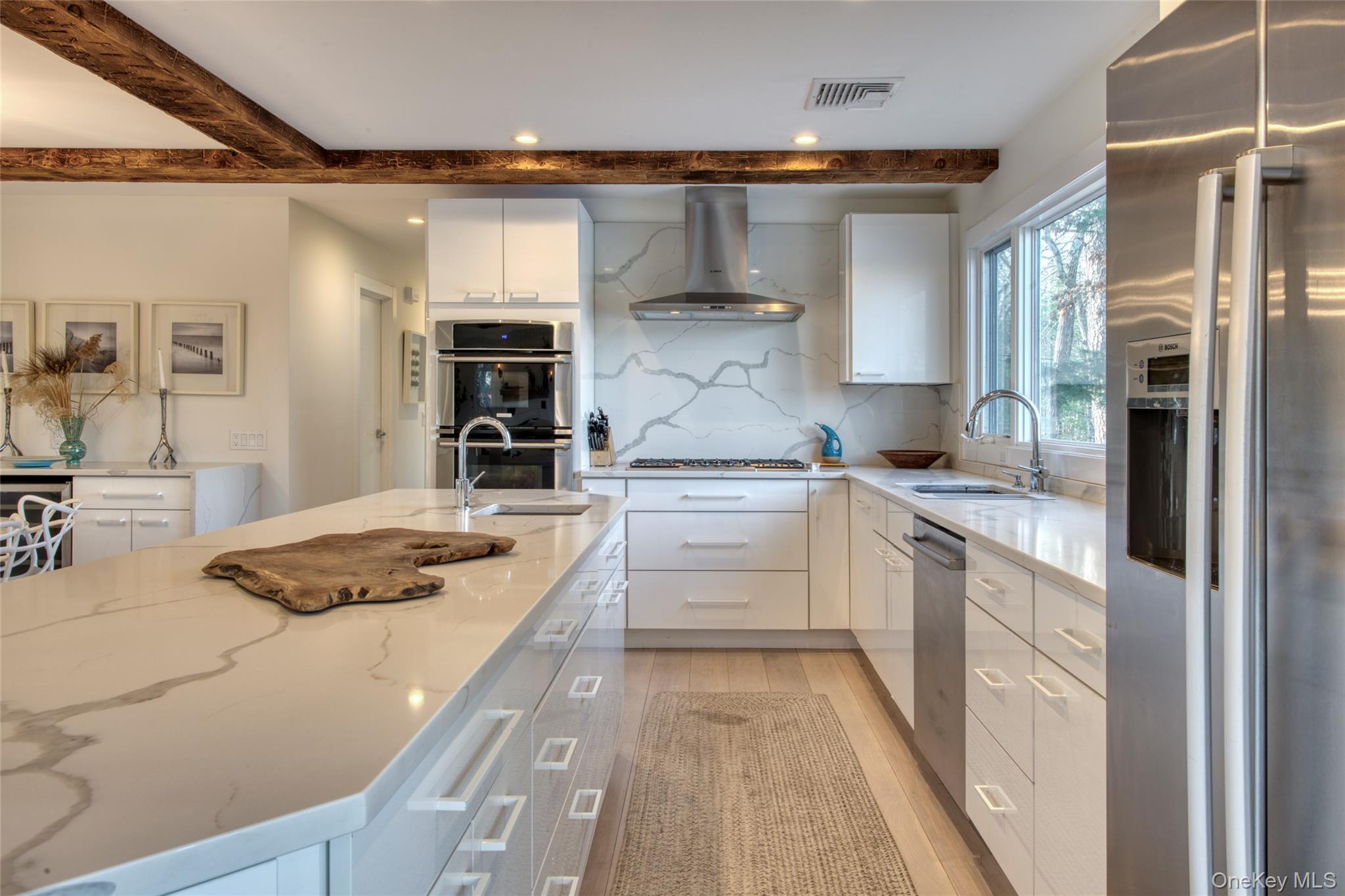57 Big Fresh Pond Road Southampton, NY 11968 - Photo 4 of 18 a kitchen with a stove a sink and a refrigerator