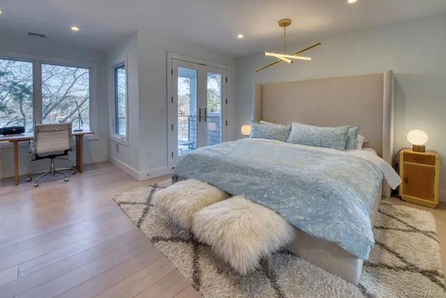a bathroom with a tub a sink and mirror