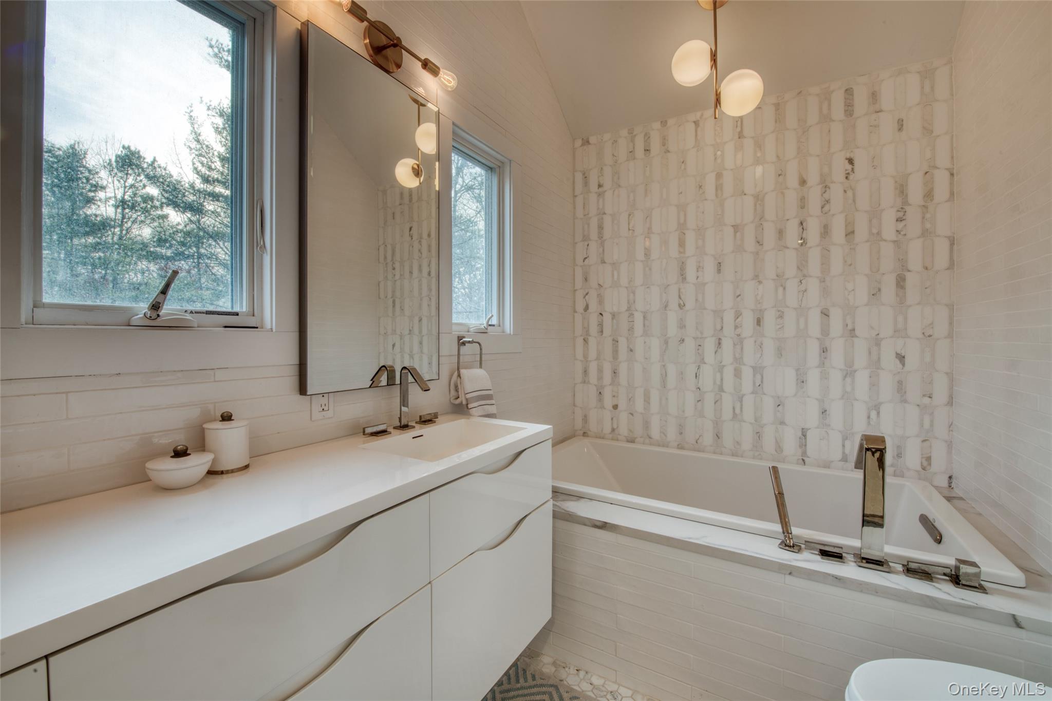 57 Big Fresh Pond Road Southampton, NY 11968 - Photo 8 of 18 a bathroom with a tub a sink and mirror