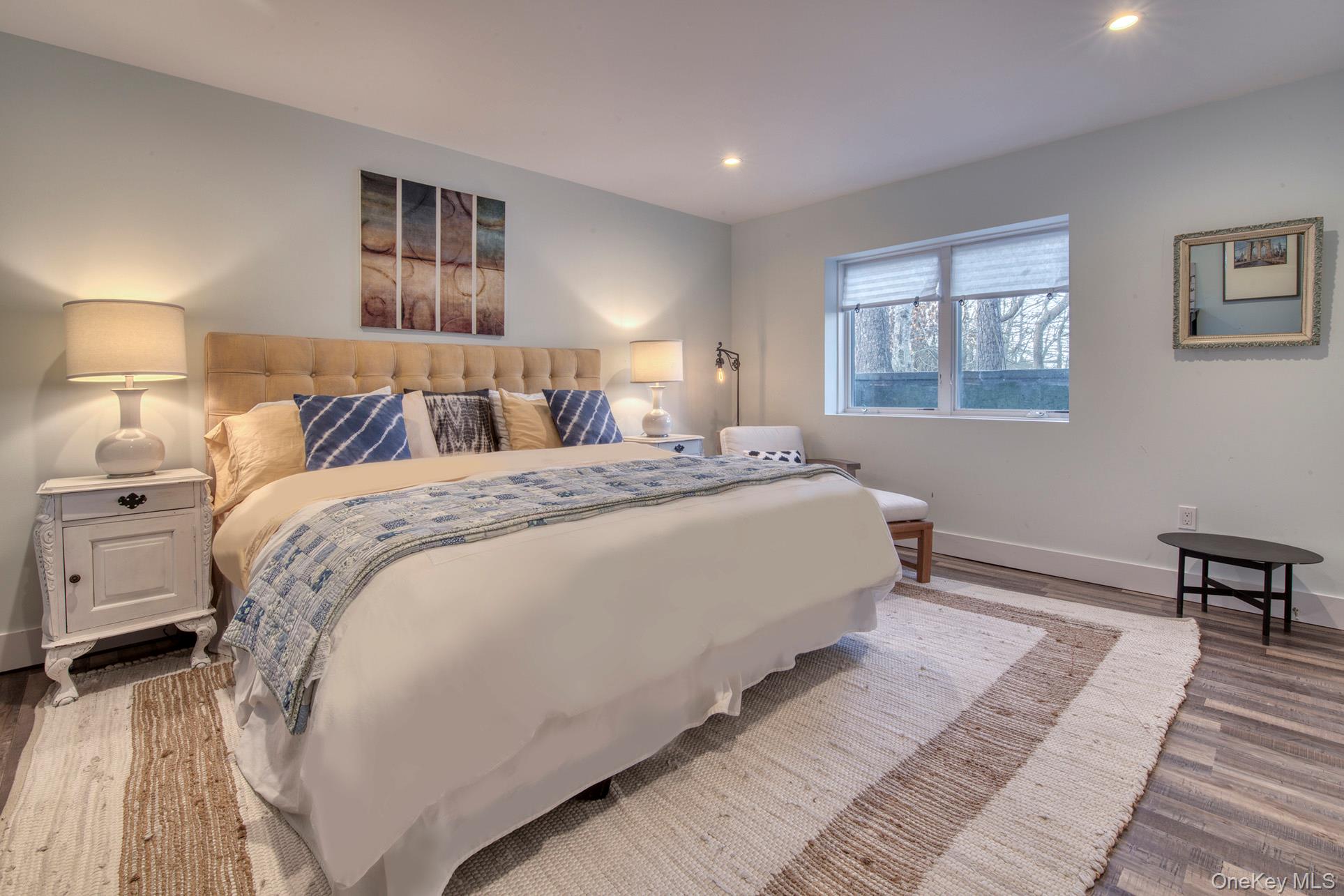 57 Big Fresh Pond Road Southampton, NY 11968 - Photo 9 of 18 a bedroom with a bed wooden floor and window