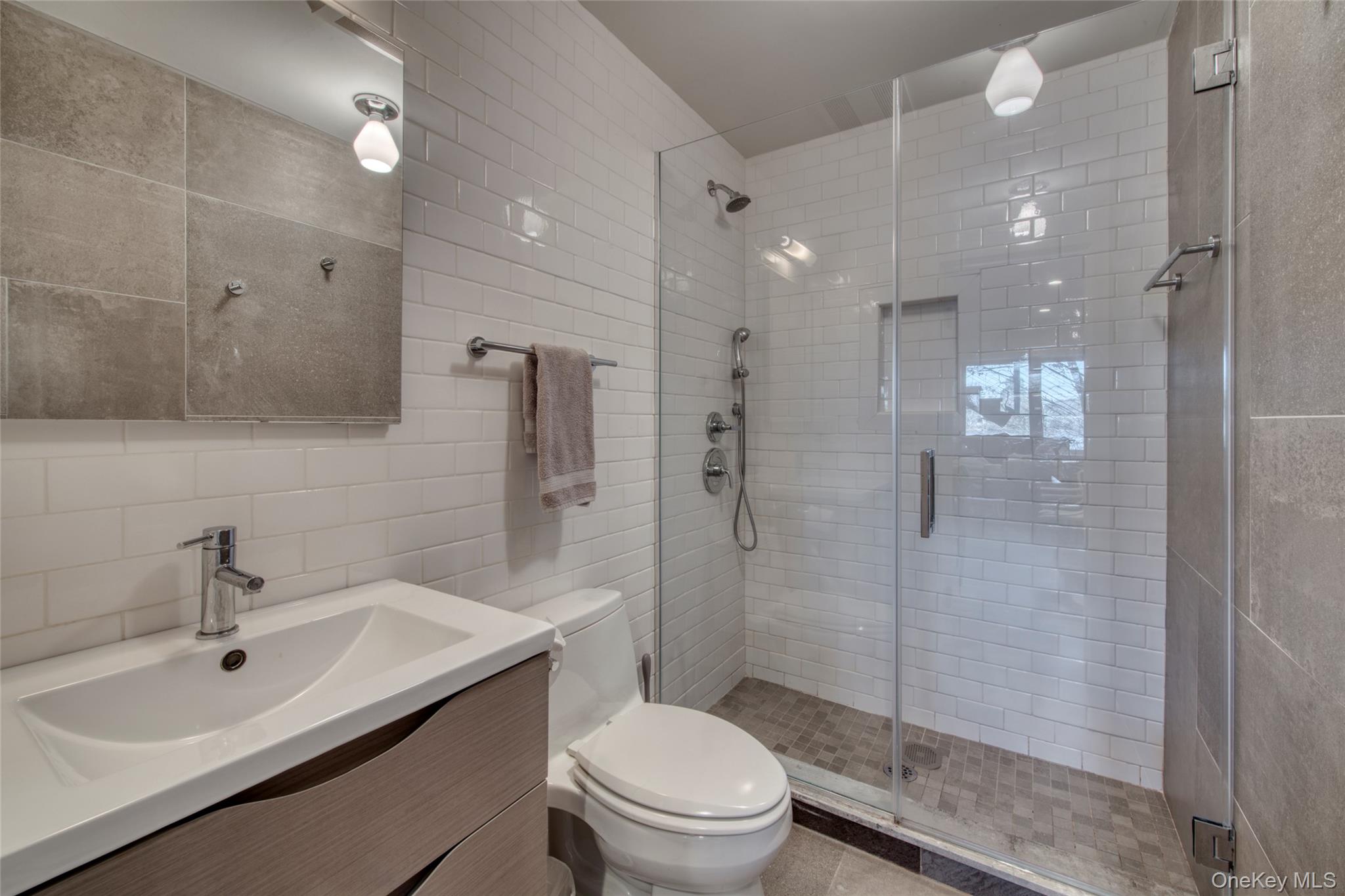 57 Big Fresh Pond Road Southampton, NY 11968 - Photo 10 of 18 a bathroom with a sink a toilet and shower