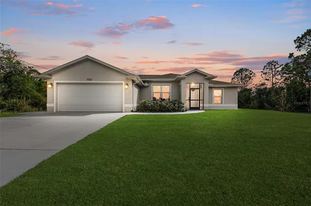 a front view of house with yard and green space