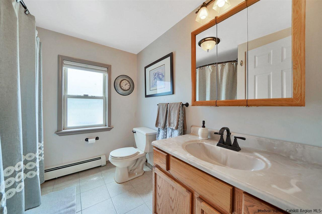 78 E Road Wallkill, NY 12589 - Photo 13 of 27 a bathroom with a toilet sink and mirror
