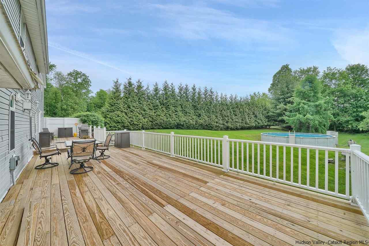 78 E Road Wallkill, NY 12589 - Photo 24 of 27 a view of a patio with two chairs and table on the wooden floor