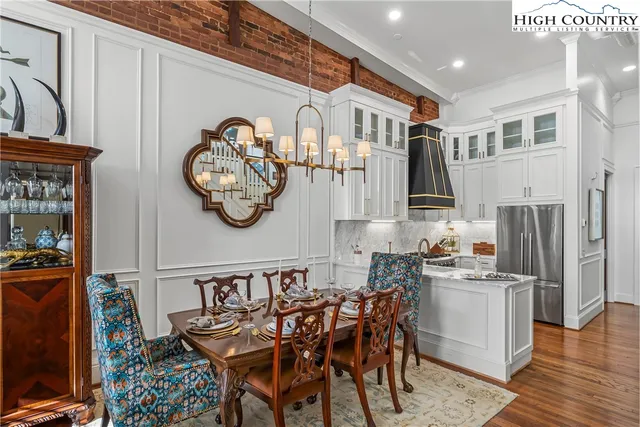 a dining room with furniture and a chandelier