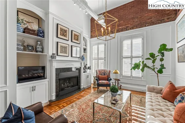 a living room with furniture fireplace and window
