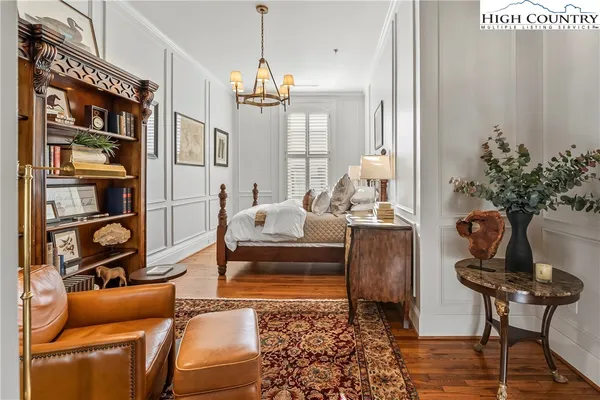 a living room with furniture a rug and a potted plant