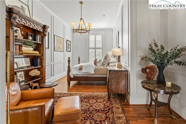 a living room with furniture a rug and a potted plant
