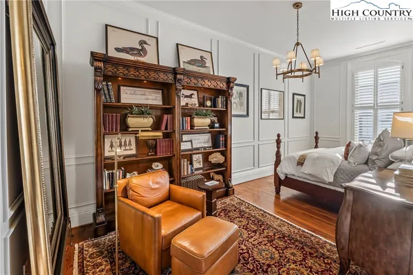 a bedroom with furniture and a chandelier