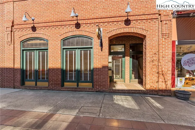 a view of a grey house with door