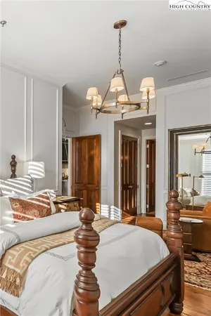 a living room with furniture chandelier and window