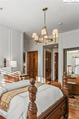 a living room with furniture chandelier and window