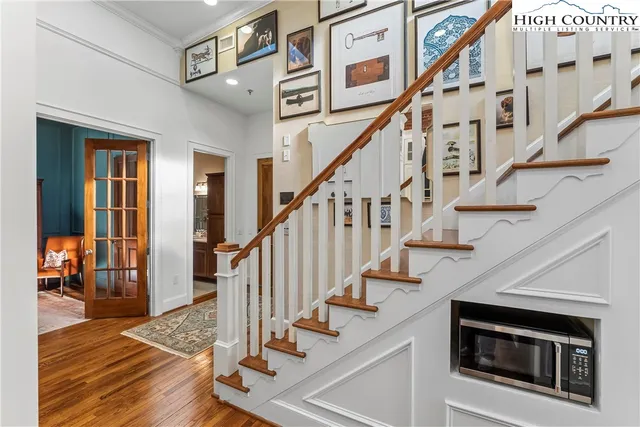a view of entryway and hall with wooden floor