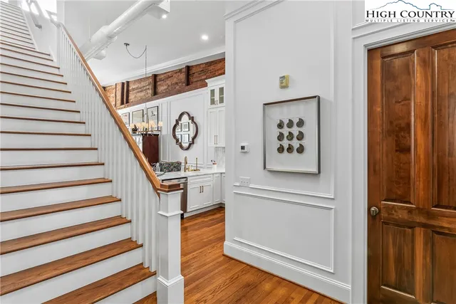 a view of a hallway with wooden floor and entryway