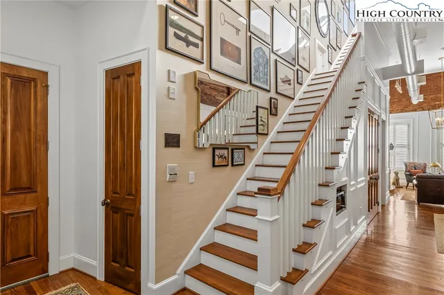 a view of entryway with wooden floor and stairs