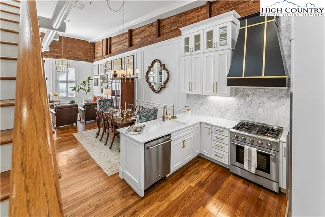 a kitchen with a stove oven and a table