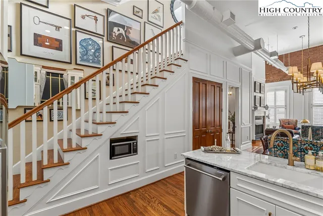 a view of entryway and hall with wooden floor