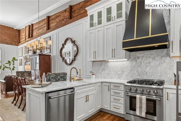 a kitchen with stainless steel appliances granite countertop a stove and a sink