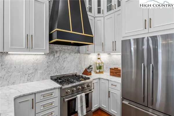 a kitchen with stainless steel appliances a stove and a refrigerator