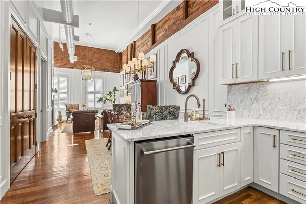 a kitchen with stainless steel appliances granite countertop a sink and cabinets