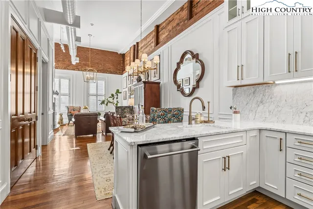 a kitchen with stainless steel appliances granite countertop a sink and cabinets