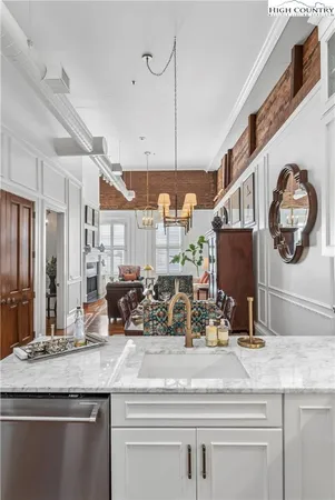 a kitchen with counter top and stainless steel appliances