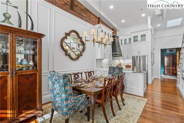 a view of a dining room with furniture and wooden floor