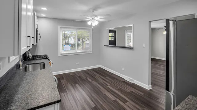 a view of a room with wooden floor and a window