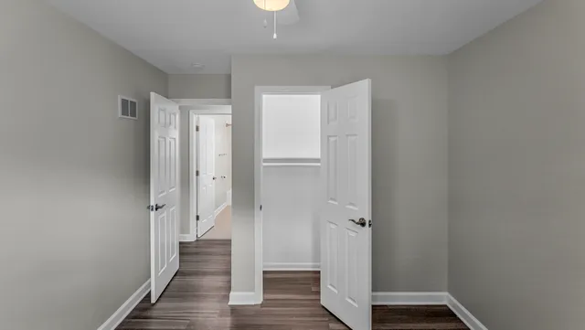 a view of a hallway with wooden floor