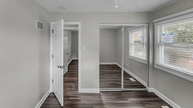 a view of entryway and hall with wooden floor