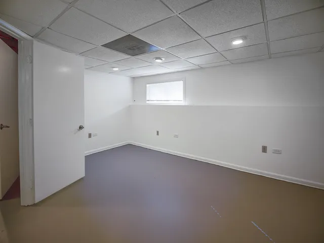 an empty room with a empty space and windows