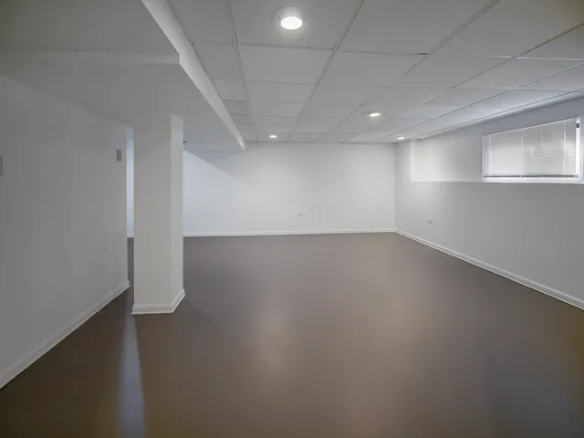 an empty room with a empty space and windows