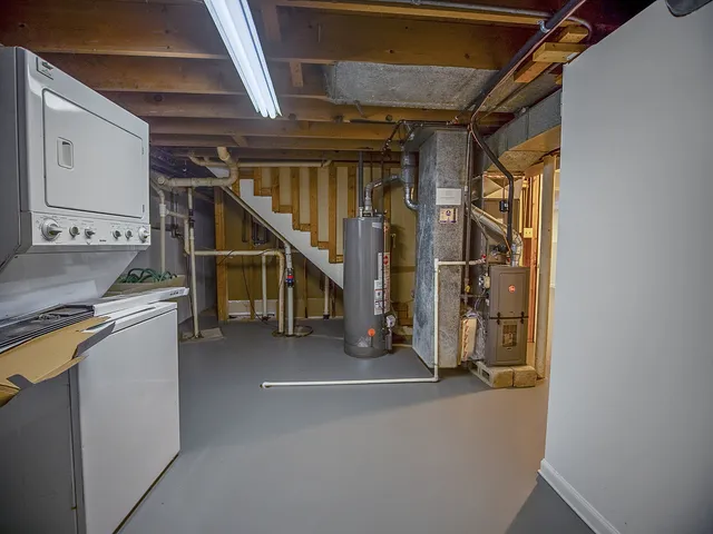 a view of water heater room with stairs