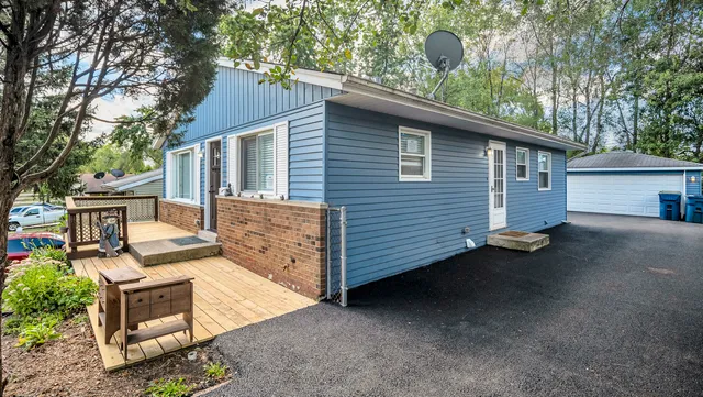 a view of a house with a backyard and a garage