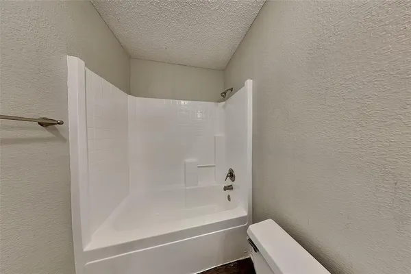 a bathroom with a bathtub and a toilet