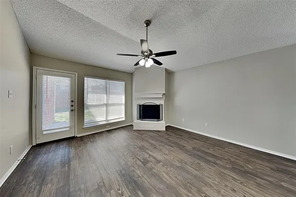 wooden floor in an empty room with a fireplace
