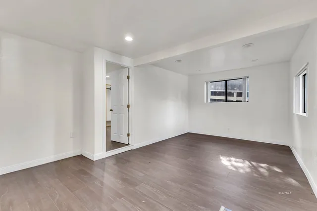 a kitchen with a table chairs a stove a sink dishwasher a dining table and chairs with wooden floor