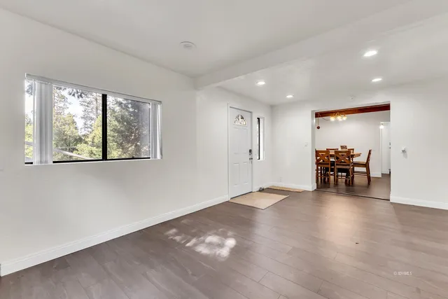 a kitchen with cabinets stainless steel appliances and wooden floor