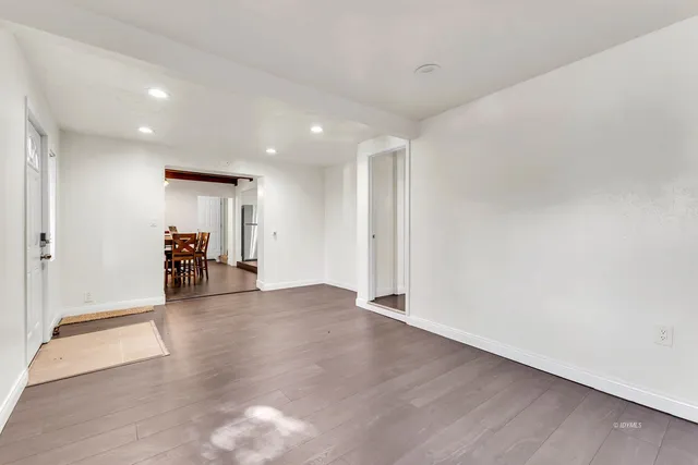 a kitchen with stainless steel appliances white cabinets a stove top oven a sink and dishwasher