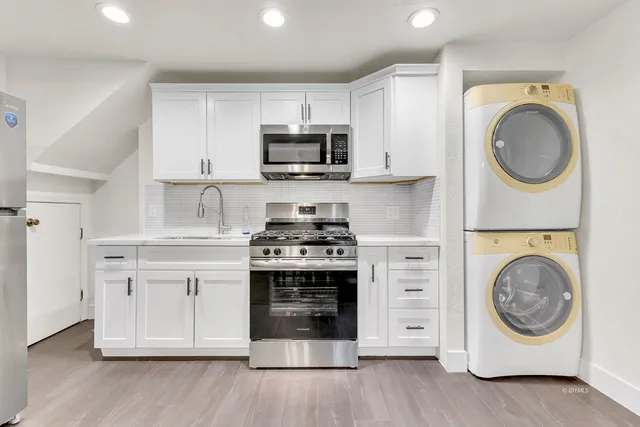 a bathroom with a toilet a sink a shower and a mirror