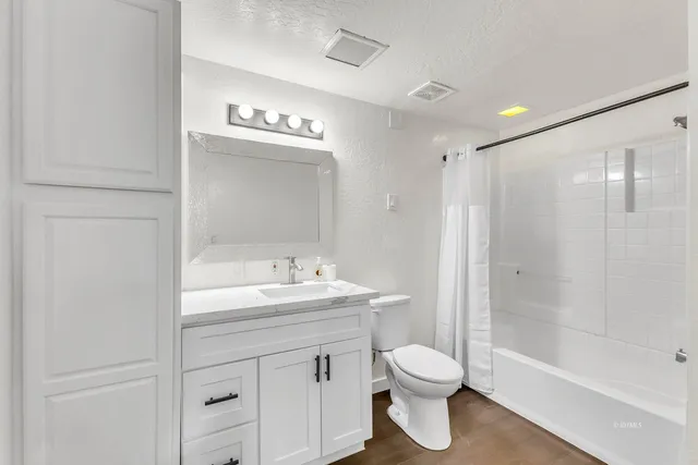 a kitchen with wooden cabinets stove top oven and sink